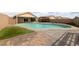 Backyard view featuring a large pool, covered patio, and well-maintained landscaping for relaxation at 4611 Julesburg Dr, Las Vegas, NV 89139