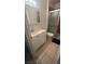 Well-lit bathroom with a shower, a toilet, and a vanity with a sink and a mirrored medicine cabinet at 4868 Treetrunk Ave, Las Vegas, NV 89147