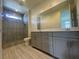 Bathroom with double sink vanity, tile floor, glass shower and large mirror at 492 Pear Lake St, Las Vegas, NV 89138