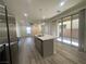 Bright kitchen features a large island, stainless steel appliances, and sliding glass doors for natural light and outdoor access at 492 Pear Lake St, Las Vegas, NV 89138