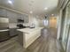 Modern kitchen features stainless steel appliances, white countertops, sleek cabinetry, and access to outdoor space at 492 Pear Lake St, Las Vegas, NV 89138