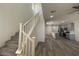 Inviting living room boasts hardwood floors, a staircase, and an open floor plan leading to the contemporary kitchen at 492 Pear Lake St, Las Vegas, NV 89138