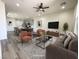 Open concept living room featuring modern furniture, a ceiling fan, and an adjacent kitchen with a center island at 492 Pear Lake St, Las Vegas, NV 89138