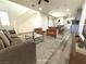 Bright living room boasts stylish furniture, hardwood floors, and an open floor plan leading to the kitchen at 492 Pear Lake St, Las Vegas, NV 89138