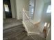 Carpeted staircase with a white railing, with a view of the upper hallway and an open living area downstairs at 492 Pear Lake St, Las Vegas, NV 89138