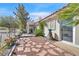 Beautiful backyard featuring a stone pathway, mature landscaping, and access to the property at 4932 Forest Oaks Dr, Las Vegas, NV 89149