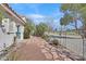 Charming backyard with stone pathway leading to the golf course and mature landscaping at 4932 Forest Oaks Dr, Las Vegas, NV 89149