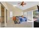 Bright main bedroom featuring tiled floor, shutters, closet with sliding mirror doors, and sliding door at 4932 Forest Oaks Dr, Las Vegas, NV 89149