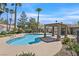 Gorgeous community pool and pool house with covered seating and desert landscaping at 4932 Forest Oaks Dr, Las Vegas, NV 89149
