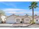 Charming single-story home featuring stucco exterior, desert landscaping, and a classic tile roof at 4932 Forest Oaks Dr, Las Vegas, NV 89149