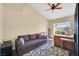 Inviting living room with comfortable sofa, desk, and window view at 4932 Forest Oaks Dr, Las Vegas, NV 89149