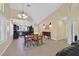 Open-concept dining and living area featuring vaulted ceilings, natural light, and modern kitchen nearby at 4932 Forest Oaks Dr, Las Vegas, NV 89149