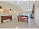 Spacious dining and living area featuring tiled floor, vaulted ceiling, and modern lighting fixtures at 4932 Forest Oaks Dr, Las Vegas, NV 89149