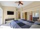 Bright main bedroom boasts a ceiling fan, large closet, and access to the ensuite bath at 4932 Forest Oaks Dr, Las Vegas, NV 89149