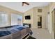 Spacious main bedroom featuring tile floors, ceiling fan, closet and ensuite bathroom at 4932 Forest Oaks Dr, Las Vegas, NV 89149