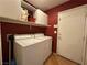 Functional laundry room with a washer, dryer, and convenient shelving at 5034 Sail Rock Pl, North Las Vegas, NV 89031