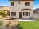 This beautiful backyard has two chairs, grass, and a brick patio at 5120 First Sun St, North Las Vegas, NV 89081