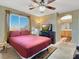 Cozy bedroom featuring a ceiling fan, and an attached bathroom with carpeted floors at 5120 First Sun St, North Las Vegas, NV 89081