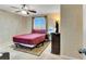 Bedroom featuring carpet floors, ceiling fan, window and a dresser at 5120 First Sun St, North Las Vegas, NV 89081