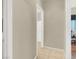 Hallway with views into bathroom and office, featuring tile flooring and neutral paint at 5120 First Sun St, North Las Vegas, NV 89081