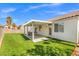 Home featuring covered patio and artificial grass at 5227 Zebra Ct, North Las Vegas, NV 89031