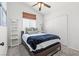 Inviting bedroom with a modern bed, white ladder shelves, and a window with woven shades at 5227 Zebra Ct, North Las Vegas, NV 89031