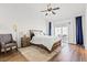 Bright bedroom with a ceiling fan, neutral walls, a sliding glass door, and a wooden bed frame at 5227 Zebra Ct, North Las Vegas, NV 89031