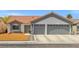 Charming single-story home featuring a terra cotta roof, two-car garage, and low-maintenance landscaping at 5227 Zebra Ct, North Las Vegas, NV 89031
