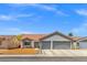 Charming single-story home featuring a terra cotta roof, two-car garage, and low-maintenance landscaping at 5227 Zebra Ct, North Las Vegas, NV 89031
