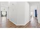 Hallway with hardwood floors leading to multiple rooms with a neutral paint palette at 5227 Zebra Ct, North Las Vegas, NV 89031