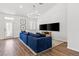 Bright living room featuring a modern lighting fixture, shutters, and hardwood floors at 5227 Zebra Ct, North Las Vegas, NV 89031