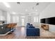 Bright living room featuring a breakfast bar, modern lighting, and hardwood floors at 5227 Zebra Ct, North Las Vegas, NV 89031