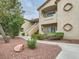 Exterior of a condo building with tan stucco, small balconies, and well-maintained landscaping at 5415 W Harmon Ave # 1074, Las Vegas, NV 89103