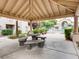 Inviting common area featuring covered picnic tables and lush landscaping for relaxing outdoor gatherings and community enjoyment at 5415 W Harmon Ave # 1074, Las Vegas, NV 89103