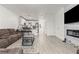 Cozy living room with modern fireplace, sleek floors, and an open layout connected to the kitchen at 5415 W Harmon Ave # 1074, Las Vegas, NV 89103