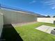 Fully fenced backyard with an artificial grass lawn and concrete patio for relaxing and outdoor entertaining at 545 Thea St # 1315, Henderson, NV 89052