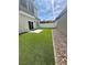 Backyard featuring artificial grass, a white fence, and rock landscaping at 545 Thea St # 1315, Henderson, NV 89052