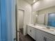 Large bathroom featuring dual sinks, white cabinets, gray flooring and ample counter space at 545 Thea St # 1315, Henderson, NV 89052