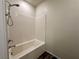 Bathtub and shower featuring white subway tile, brushed nickel hardware and modern shower head at 545 Thea St # 1315, Henderson, NV 89052