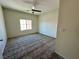 Cozy bedroom with natural light, ceiling fan, and neutral carpeting at 545 Thea St # 1315, Henderson, NV 89052