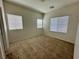 Bedroom with neutral carpet, three windows, and two electrical outlets to power lights and devices at 545 Thea St # 1315, Henderson, NV 89052