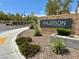 Inviting community sign 'The Hudson' set amidst lush landscaping, enhancing the neighborhood's appeal at 545 Thea St # 1315, Henderson, NV 89052