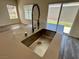 Modern kitchen featuring stainless steel sink with a large window and glass sliding door at 545 Thea St # 1315, Henderson, NV 89052