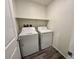 Neat laundry room with washer, dryer, storage shelf and gray wood-look flooring at 545 Thea St # 1315, Henderson, NV 89052