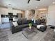 Bright living room open to dining and kitchen, features modern gray sofa and updated flooring at 545 Thea St # 1315, Henderson, NV 89052