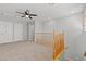 Neutral carpeted loft featuring two entry doors and a ceiling fan at 5808 Sierra Cliff St, North Las Vegas, NV 89031