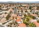 Wide aerial view showcases the neighborhood layout with tidy landscaping and community tennis court at 650 Hermosa Palms Ave, Las Vegas, NV 89123