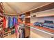 Spacious walk-in closet featuring custom wood shelving and ample storage space for clothes and accessories at 650 Hermosa Palms Ave, Las Vegas, NV 89123