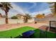 Backyard featuring artificial turf, decorative rocks, and seating area at 6538 Astorville Ct, Las Vegas, NV 89110