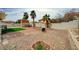 Spacious backyard featuring a shed, palm trees, gravel, and a fire pit area for outdoor enjoyment at 6538 Astorville Ct, Las Vegas, NV 89110